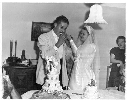 Rosemarie feeding Wally a piece of wedding cake