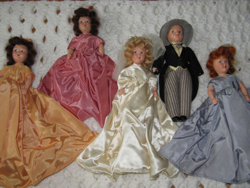 dolls dressed in replicas of bride and bridesmaids dresses, also groom doll