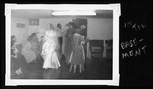 Rosemarie and wedding guests celebrating in the basement